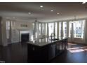 Bright living room showcases large windows, hardwood floors, a fireplace, and an open layout at 10420 Sablewood Drive Dr # 102, Raleigh, NC 27617