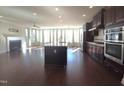 Spacious living room features a fireplace, large windows, an open floorplan, and modern finishes at 10420 Sablewood Drive Dr # 102, Raleigh, NC 27617