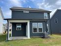 Rear exterior view featuring a covered patio and well-maintained lawn at 116 Willow Cameron Way, Angier, NC 27501