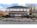 Two-story home featuring a covered front porch and mature landscaping at 121 Hamilton St, Henderson, NC 27536