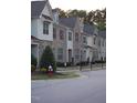 Attractive townhomes line a neighborhood street with manicured landscaping at 1319 Lakestone Village Ln, Fuquay Varina, NC 27526