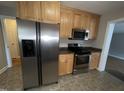 Kitchen boasts stainless steel appliances and wood cabinets, enhancing functionality at 1600 Buffaloe Rd, Garner, NC 27529