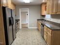 Well-lit kitchen features wooden cabinets, stainless steel appliances, and neutral countertops at 1600 Buffaloe Rd, Garner, NC 27529