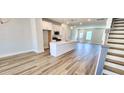Open-concept living space with a modern kitchen featuring a center island and stainless steel appliances at 1905 Plott Balsam Dr, Wendell, NC 27591