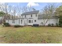 Spacious backyard with lush lawn, mature trees, and access to sunroom with a hot tub at 2015 Pratt Cir, Franklinton, NC 27525