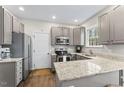 Well-lit kitchen featuring granite counters, stainless steel appliances, and ample cabinet space at 2015 Pratt Cir, Franklinton, NC 27525