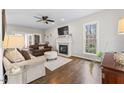 Bright living room featuring a fireplace, hardwood floors, and large windows providing natural light at 2015 Pratt Cir, Franklinton, NC 27525