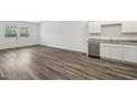Open living area with hardwood flooring, white walls, cabinets, and lots of natural light at 2058 Glen Crossing Dr, Durham, NC 27704