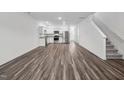 Spacious living room featuring wood floors, white walls and an open concept view to the kitchen at 2060 Glen Crossing Dr, Durham, NC 27704