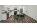 Modern kitchen with stainless steel appliances and wood laminate flooring at 2062 Glen Crossing Dr, Durham, NC 27704