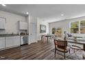Open-concept living space with hardwood floors and a seamless flow to the kitchen and dining area at 2117 Trailside Dr, Durham, NC 27704
