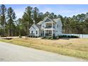 Attractive two-story home with gray siding, stone accents, and inviting front porch and balcony at 220 Green Haven Blvd, Youngsville, NC 27596