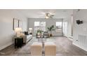 Inviting living room featuring large windows, stylish furniture, and a cozy area rug at 240 Amber Acorn Ave, Raleigh, NC 27603