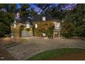 Elegant stone home featuring a turret entry, balcony, two-car garage, and manicured landscaping at 2658 Davis St, Raleigh, NC 27608