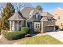 Charming two-story brick home featuring manicured landscaping, a two-car garage, and a classic design at 3025 Osterley St, Raleigh, NC 27614