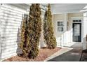Charming home exterior with a welcoming front porch and elegant landscaping with well manicured trees at 314 Fenmore Pl, Cary, NC 27519