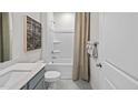 Well-lit bathroom with a combination tub and shower, complemented by neutral décor and modern fixtures at 369 Swift Creek Farm Ln, Clayton, NC 27520