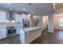 Bright kitchen with stainless steel appliances, granite countertops, and a functional island at 375 Thomas Arnold Rd, Zebulon, NC 27597