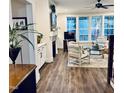 Bright living room with hardwood floors, fireplace, and large windows offering natural light and scenic views at 564 Woodbridge Ct, Wake Forest, NC 27587