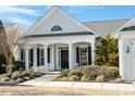 Inviting front entrance with black shutters, columns, and a well-manicured landscape at 627 Aylestone Dr, Cary, NC 27519
