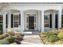 Front entrance with a black door framed by sidelights and white columns at 627 Aylestone Dr, Cary, NC 27519