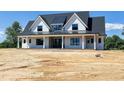 Eye-catching two-story home boasting a charming front porch, symmetrical design and desirable curb appeal at 6509 Zebulon Rd, Wake Forest, NC 27587