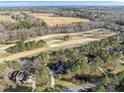 Stunning aerial view showcases a home nestled amongst a golf course at 7220 Hasentree Way, Wake Forest, NC 27587