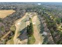 Scenic aerial view of a golf course surrounded by homes and wooded areas at 7220 Hasentree Way, Wake Forest, NC 27587