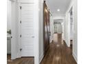 Hallway with white trim and a sliding wooden barn door leading to living area at 729 Daniel Ridge Rd, Wendell, NC 27591