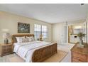 Well lit bedroom with a floral theme, featuring a queen size bed, and an open bathroom at 7712 Falcon Rest Cir, Raleigh, NC 27615