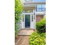 Inviting front entrance with sidelights, brick accents, and manicured landscaping at 7712 Falcon Rest Cir, Raleigh, NC 27615