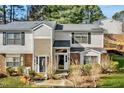 Charming townhouse with gray siding, black shutters, and well-maintained landscaping at 7712 Falcon Rest Cir, Raleigh, NC 27615