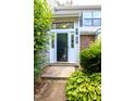 Inviting front entryway with a glass storm door, sidelights, and well-maintained landscaping at 7712 Falcon Rest Cir, Raleigh, NC 27615