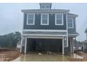 New two-story home with gray siding and a two-car garage with the door open at 79 Willow Cameron Way, Angier, NC 27501