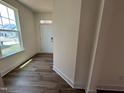 A bright foyer with wood-look floors and a large window by the front door at 79 Willow Cameron Way, Angier, NC 27501
