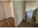 Open foyer leads to the living area, showcasing modern wood-look flooring at 79 Willow Cameron Way, Angier, NC 27501