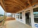 Covered patio with wooden frame and concrete base overlooking the neighborhood at 79 Willow Cameron Way, Angier, NC 27501