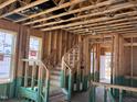 Unfinished staircase showing the frame, steps, and handrail under construction at 79 Willow Cameron Way, Angier, NC 27501
