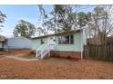Charming one-story home with light green siding, brick foundation, and a well-manicured front yard at 809 S Plum St, Durham, NC 27701