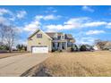 Traditional two-story home with two-car garage, dormer windows, manicured front yard and covered front porch entrance at 8116 Hartwood Glen Cir, Willow Springs, NC 27592