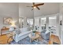 Bright living room with a ceiling fan, hardwood floors, and stylish furniture at 8116 Hartwood Glen Cir, Willow Springs, NC 27592