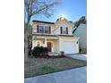 Inviting two-story home featuring a garage, landscaped front yard, and red shutters at 813 Woodside Park Ln, Durham, NC 27704