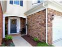 Inviting front entry with a decorative wreath, stone accents, and a cozy sitting area at 8329 Pilots View Dr, Raleigh, NC 27617