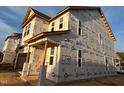 New construction with DRB Homes building wrap and visible window frames in a multi-story home at 89 Willow Cameron Way, Angier, NC 27501