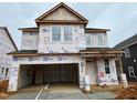 New construction home featuring a garage and ample windows at 89 Willow Cameron Way, Angier, NC 27501