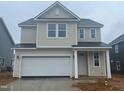 Two-story home features a two-car garage, neutral siding and white trim at 89 Willow Cameron Way, Angier, NC 27501