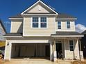 Two-story home under construction features a two-car garage, neutral siding and white trim at 89 Willow Cameron Way, Angier, NC 27501
