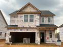 New two-story construction of a DRB Home with a garage in a new residential development at 89 Willow Cameron Way, Angier, NC 27501