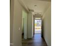 Inviting hallway with wood flooring, neutral walls, and ample natural light streaming in through the front door at 89 Willow Cameron Way, Angier, NC 27501
