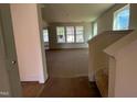 Unfurnished living room with large windows allowing for ample natural light and views of the neighborhood at 89 Willow Cameron Way, Angier, NC 27501